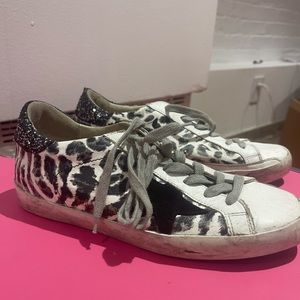 golden goose superstar sneaker in black and white animal print with sparkly heel